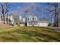 Charming home with a well-maintained lawn, integrated garage and beautiful trees surrounding the property at 1088 Raleigh Way, Lawrenceville, GA 30043