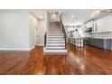 Bright, open-concept living room with gleaming hardwood floors and view of the modern kitchen and staircase at 1549 Beecher Sw St, Atlanta, GA 30310