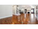 Spacious, light-filled living room featuring hardwood floors, a fireplace and an open floor plan at 1549 Beecher Sw St, Atlanta, GA 30310