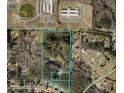 Aerial view showcasing property boundaries with wooded areas and nearby community features at 744 Hampton Locust Grove Rd, Hampton, GA 30228