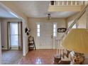 Bright foyer with tile flooring, staircase, and view into adjacent rooms at 744 Hampton Locust Grove Rd, Hampton, GA 30228