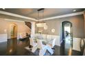 Elegant dining room with a modern chandelier, large windows, and wainscoting at 1365 Willis Lake Dr, Kennesaw, GA 30152