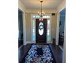 Elegant foyer with dark wood floors and a decorative chandelier at 1580 Reids Ferry Way, Marietta, GA 30062