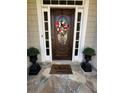 Close-up of a welcoming front door, complete with floral wreath and ornate planters at 1580 Reids Ferry Way, Marietta, GA 30062
