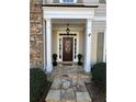 Inviting front entrance with a decorative wreath and stone walkway at 1580 Reids Ferry Way, Marietta, GA 30062
