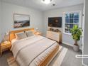 Cozy bedroom with a comfortable bed, modern decor, and a view of the outdoors at 1935 Wenton Pl, Lawrenceville, GA 30044
