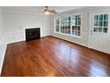 Bright living room featuring a fireplace, large windows, and hardwood floors at 1935 Wenton Pl, Lawrenceville, GA 30044