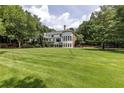 Expansive backyard with meticulously maintained lawn and views of the elegant home and surrounding trees at 4500 Candacraig, Alpharetta, GA 30022