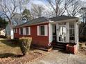 A cozy red brick house with a sunroom addition and well-maintained landscaping at 804 Maynard Ter, Atlanta, GA 30316