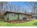 Charming ranch home with a landscaped lawn, modern garage door, and inviting front porch at 1322 Elmhurst Circle Se Cir, Atlanta, GA 30316