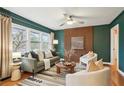 Sun-filled living room featuring a decorative wood accent wall, hardwood floors and modern furnishings at 1322 Elmhurst Circle Se Cir, Atlanta, GA 30316