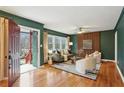 Stylish living room with hardwood floors, green walls, and decorative wooden wall at 1322 Elmhurst Circle Se Cir, Atlanta, GA 30316