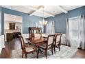 Elegant dining room showcases hardwood floors, coffered ceilings, and natural light at 3815 Beaver Swamp Rd, Loganville, GA 30052