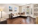 Comfortable living room features hardwood floors, neutral decor, and bay window at 3815 Beaver Swamp Rd, Loganville, GA 30052