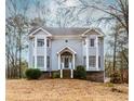 Charming two-story home features a quaint front porch, bay windows, and mature landscaping at 4900 Raquet Ct, Duluth, GA 30096