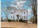 Charming two-story home features a quaint front porch, bay windows, and mature landscaping at 4900 Raquet Ct, Duluth, GA 30096