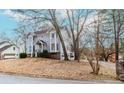 Exterior view of a two-story home with bay windows, landscaping, and a quaint front porch at 4900 Raquet Ct, Duluth, GA 30096