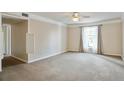 Spacious living room with neutral carpet, ceiling fan, and a bright window at 6700 Roswell Rd # 11B, Atlanta, GA 30328