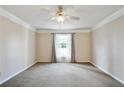 Bright living room featuring neutral carpet, ceiling fan and natural lighting at 6700 Roswell Rd # 11B, Atlanta, GA 30328