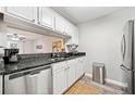 Well-lit kitchen featuring stainless steel appliances and a view into the living room at 3655 Habersham Ne Rd # B129, Atlanta, GA 30305