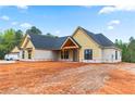 Beautiful new home with architectural roof, board and batten siding, and a covered porch at 628 Sandhill Hickory Level Rd, Carrollton, GA 30116