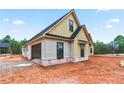 View of a new home under construction with board and batten siding and an attached garage at 628 Sandhill Hickory Level Rd, Carrollton, GA 30116