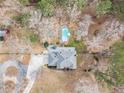 Aerial view showcases a private backyard with a pool and lush greenery at 2331 Rabbit Farm Cir, Loganville, GA 30052