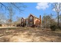 Two-story brick home highlighting the backyard with plenty of room at 2331 Rabbit Farm Cir, Loganville, GA 30052