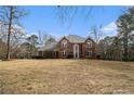 Elegant brick home with a beautifully landscaped front yard and arched windows at 2331 Rabbit Farm Cir, Loganville, GA 30052