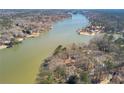 Scenic aerial view of a lakefront property surrounded by lush greenery at 2506 Emerald Dr, Jonesboro, GA 30236