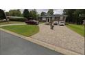 Brick home exterior featuring an expansive driveway and meticulously maintained lawn, enhancing curb appeal at 3962 Chicamauga Ne Dr, Kennesaw, GA 30144