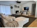 Cozy living room featuring a modern fireplace, plush sofa, and entertainment center for ultimate comfort at 3962 Chicamauga Ne Dr, Kennesaw, GA 30144