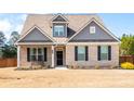 Charming brick home features a dark front door, black shutters, and manicured landscaping at 1809 Hanwoo Ln, Powder Springs, GA 30127