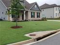 Inviting home with a well-manicured lawn, charming brick facade, and cozy front porch at 1809 Hanwoo Ln, Powder Springs, GA 30127