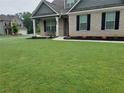 Well-maintained lawn with landscaping details highlights the facade of this inviting home at 1809 Hanwoo Ln, Powder Springs, GA 30127