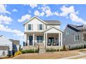 Charming two-story home with a welcoming front porch and professionally landscaped front yard at 2005 Haley Walk, Woodstock, GA 30188