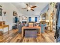 Spacious living room featuring hardwood floors, fireplace, ceiling fan and open concept at 2895 Dogwood Creek Pkwy, Duluth, GA 30096