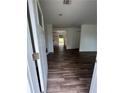 Bright entryway featuring sleek wood floors, white walls, and an open view into the home's interior at 6066 Creekford Dr, Lithonia, GA 30058