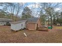 The back of the home features a wood facade, a wooden deck, and a spacious yard at 2024 Collier W Cir, Decatur, GA 30032