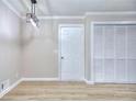 Entryway featuring modern light fixture, interior door, and closet with new flooring at 2370 Old Mill Sw Dr, Conyers, GA 30094