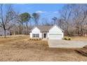 Charming home featuring white siding, a two-car garage, manicured landscaping, and a welcoming entrance at 429 Mulberry Rock Road, Temple, GA 30179