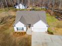 Aerial view of a charming home with a two-car garage, manicured landscaping, and a welcoming entrance at 429 Mulberry Rock Road, Temple, GA 30179