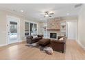Bright living room featuring a brick fireplace, stylish furniture, and hardwood floors at 472 Price Rd, Carrollton, GA 30116