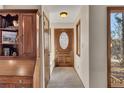 Inviting entryway with stone floors, a stained wood door with sidelight, and built-in storage at 2731 Tritt Springs Ne Dr, Marietta, GA 30062