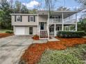 Inviting split-level home with a covered porch and well-manicured landscaping at 3783 Red Rose Ct, Loganville, GA 30052