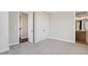 Carpeted bedroom with closet and an adjacent bathroom, offering a peaceful retreat at 264 Castleberry Station Sw Dr, Atlanta, GA 30313