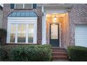Charming brick home showcasing a well-manicured front yard and inviting front entrance at 6674 Mimosa Cir, Tucker, GA 30084
