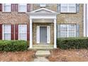 Inviting front entrance with a gray front door, complemented by manicured landscaping at 4878 Hairston Park Sq, Stone Mountain, GA 30083