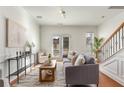 Stylish living room featuring hardwood floors, a gray sofa, and plenty of natural light at 201 16Th Nw St # 4, Atlanta, GA 30363