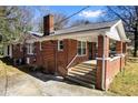 Quaint red brick house with a welcoming front porch and classic architectural details, a true gem at 2163 Ben Hill Rd, Atlanta, GA 30344